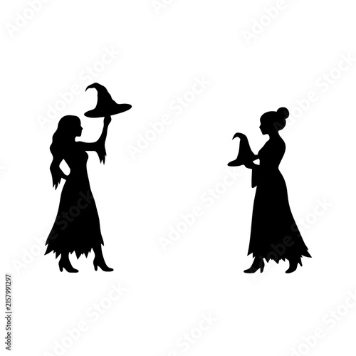 Obraz na płótnie Two Halloween witches holding pointed hats silhouette scene