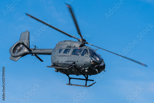 Black modern military transport helicopter flying over Budapest, Hungary