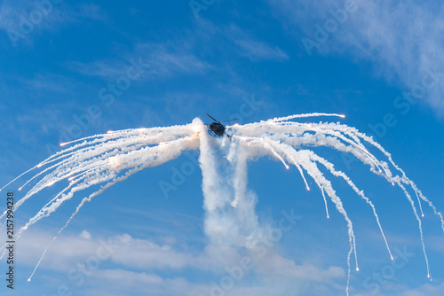 Black modern military transport helicopter shrouded in smoke over Budapest