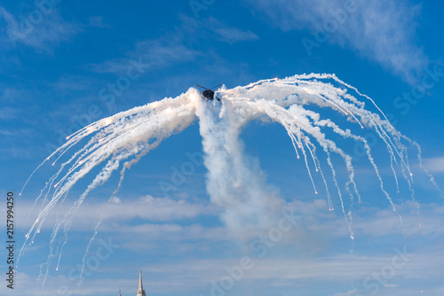 Black modern military transport helicopter shrouded in smoke over Budapest