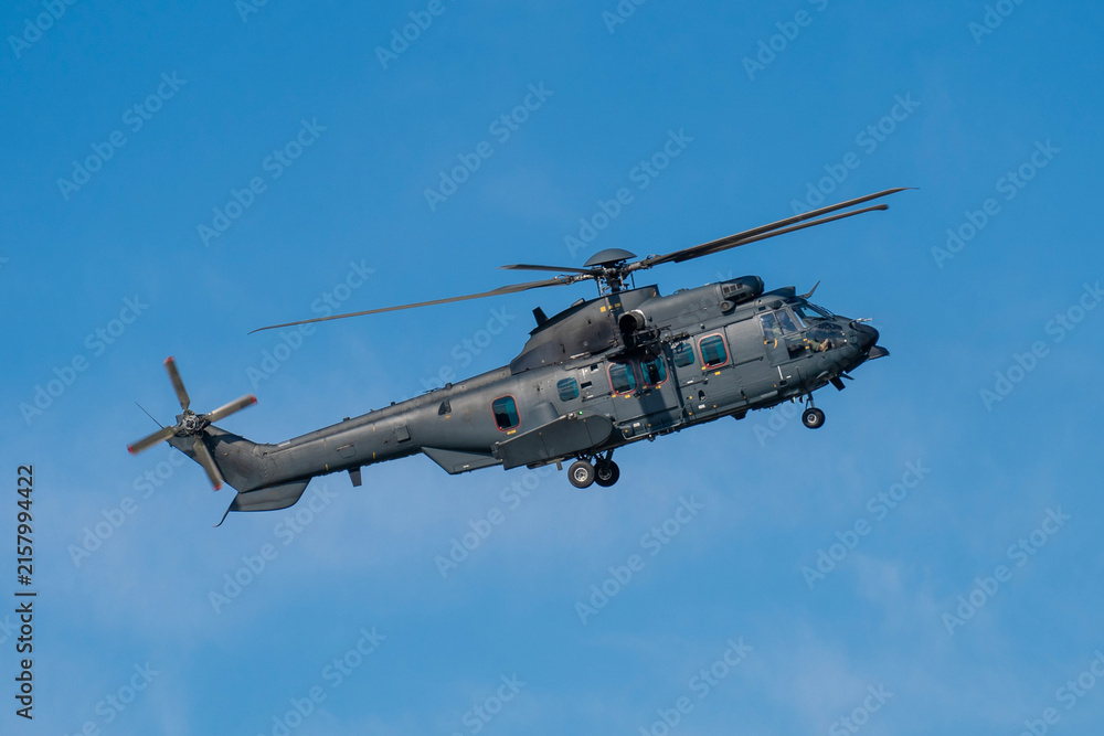 Fototapeta premium Black modern military transport helicopter flying over Budapest, Hungary