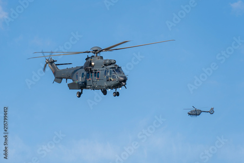 Black modern military transport helicopter flying over Budapest, Hungary