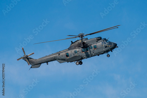 Black modern military transport helicopter flying over Budapest, Hungary