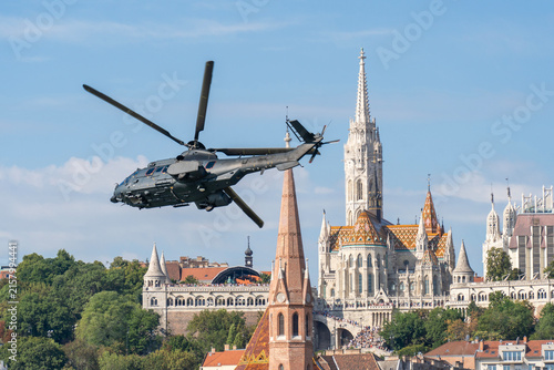 Black modern military transport helicopter flying over Budapest, Hungary