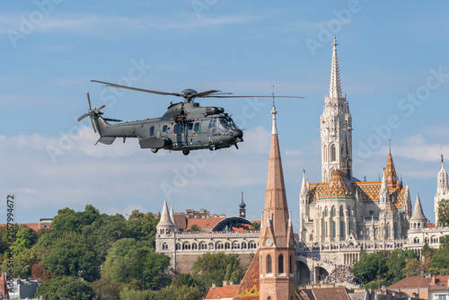Black modern military transport helicopter flying over Budapest, Hungary