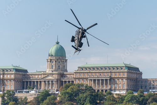 Black modern military transport helicopter flying over Budapest, Hungary