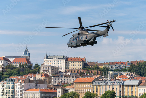 Black modern military transport helicopter flying over Budapest, Hungary
