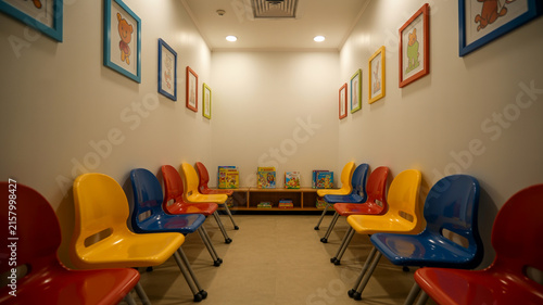 Photorealistic Pediatric Clinic Waiting Room With Colorful Chairs, Clean Walls, And Soft Lighting, No People.