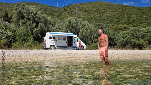 Relaxing by the crystal clear waters at kamari beach in lefkada, greece