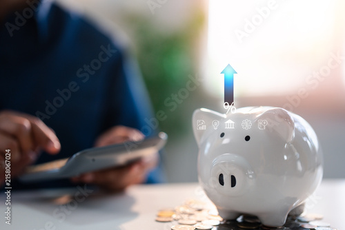 Business investment-finance accounting concept, A piggy bank saving bank for account save money percentage. Planning step up, saving money for future plan, retirement fund.