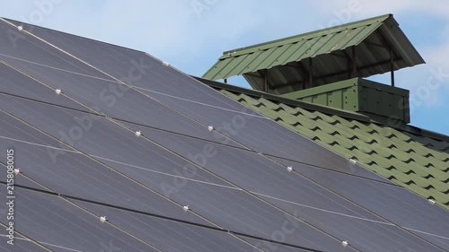 Solar panels installed on the roof of a city building. Concept of eco friendly and alternative power source. 
