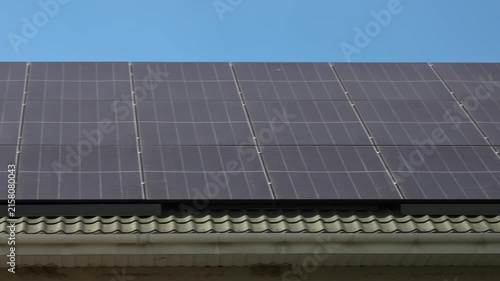 Solar panels installed on the roof of a city building. Concept of eco friendly and alternative power source. 