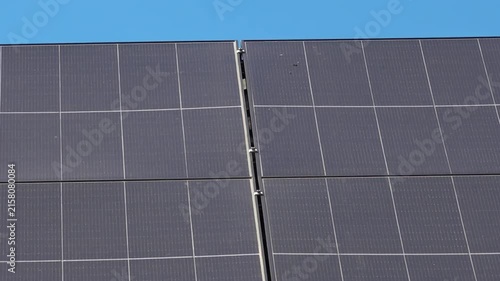 Solar panels installed on the roof of a city building. Concept of eco friendly and alternative power source. 