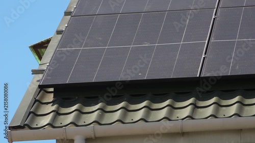 Solar panels installed on the roof of a city building. Concept of eco friendly and alternative power source. 
