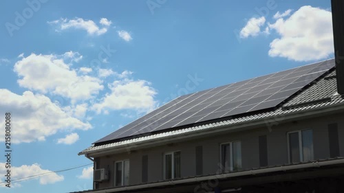 Solar panels installed on the roof of a city building. Concept of eco friendly and alternative power source. 
