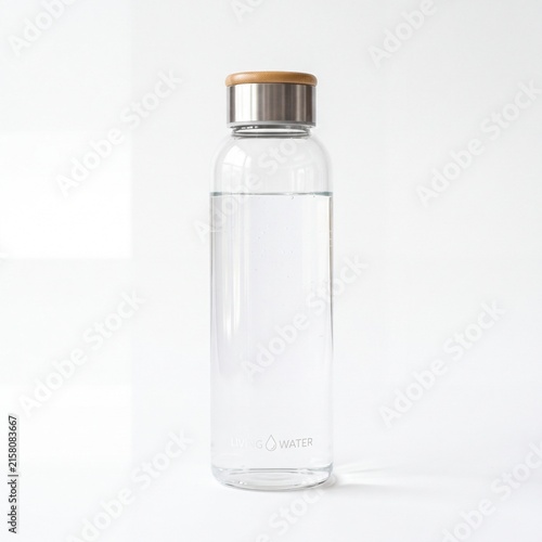 Reusable glass water bottle with bamboo lid, eco friendly clear glass tumbler, sustainable hydration flask on white background