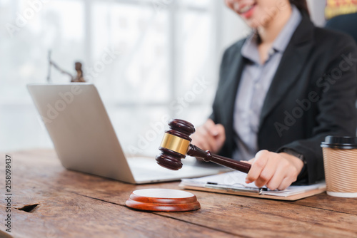 Canvas Print Judge's Decree: A professional judge in a formal suit holds a gavel, poised to deliver a verdict in a modern courtroom, symbolizing justice and legal proceedings