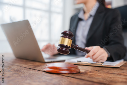 Canvas Print Lawyer at Work: A professional lawyer in a dark suit focuses on their laptop, with a gavel poised to strike, symbolizing justice and legal proceedings