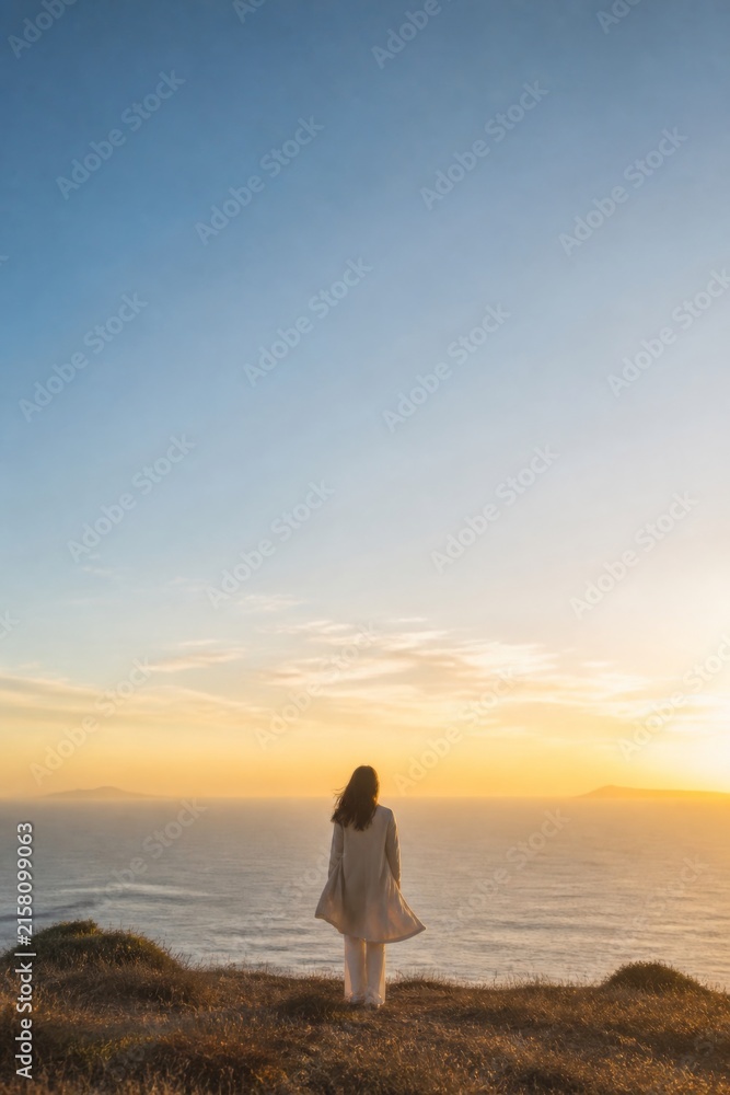 Fototapeta premium Woman standing on a coastal cliff overlooking the ocean at sunset. Peaceful travel landscape with expansive sky, solitude, reflection, and copy space for inspirational concept