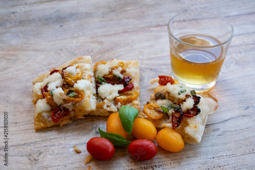 Italian focaccia pizza with glass of white wine