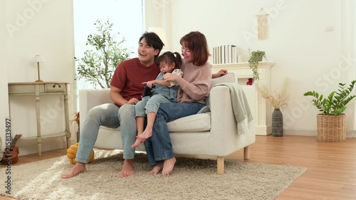 Kid Enjoys Playing Games With Parents at Home on a Playful Day While Having Fun Together