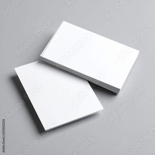 two blank business cards on a grey background