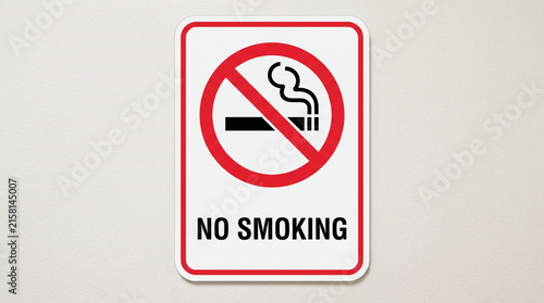 Red and White No Smoking Sign with Double Border on Plain Wall
