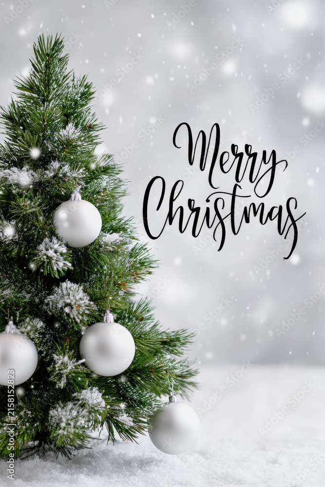 Obraz premium Christmas tree with decorations and snowy background in winter