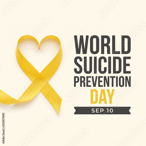 Yellow satin ribbon shaped like a heart positioned next to bold dark text commemorating world suicide prevention day held annually on the tenth of september