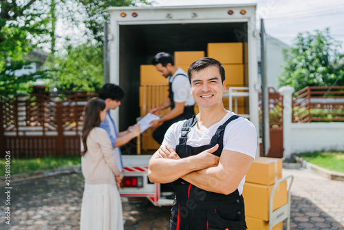 Professional Mover Smiling Confidently During Residential Relocation Service Ensuring Smooth Home Moving Experience