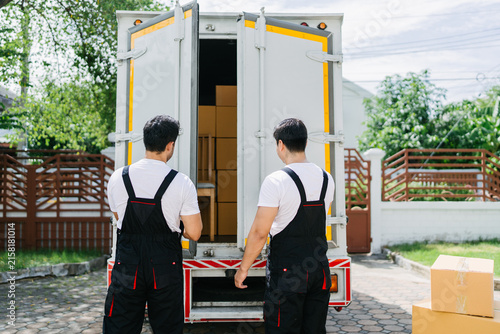 Obraz na płótnie Professional Movers Unloading Boxes During Residential Relocation, Efficient Home Delivery Service