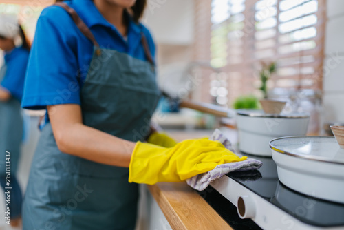 Professional Cleaner Wiping Kitchen Countertop Modern Home Hygiene Service