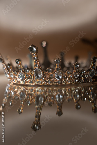Luxury Golden Crown with Crystal Details and Reflection on Brown Background. Royal Elegance. 4K