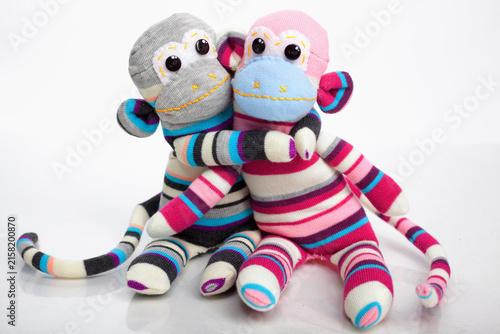 Monkey sock toys isolated on white background. Giving a hug. Full length