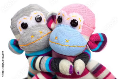 Monkey sock toys isolated on white background. Giving a hug. Close up