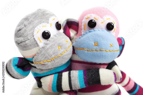 Monkey sock toys isolated on white background. Giving a hug