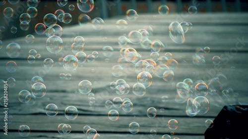 Bubble machine producing colorful soap bubbles in sunlight