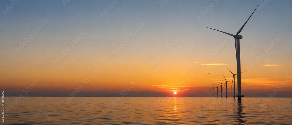 Obraz premium 21:9 Ultrawide Panoramic Photo of Offshore Wind Turbines at Sunset for ESG Green Energy Banner Concept