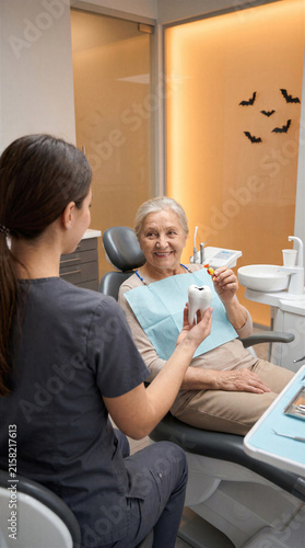 Halloween Dental Prevention Consultation With Senior Patient Tooth Model and Candy