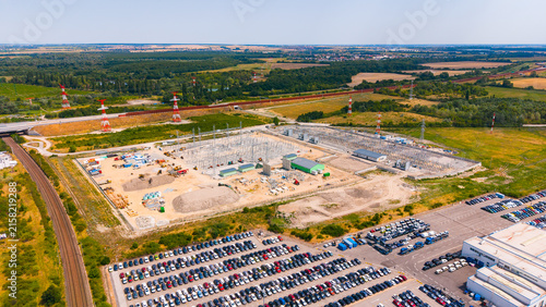 Konstfotografi Power station and parking lot located near a railway track in a rural area