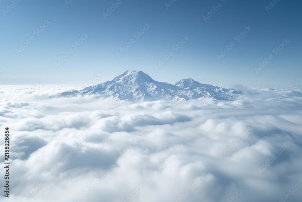 Fototapeta premium Photo of snowy mountain peek through cloud outdoors nature sky.