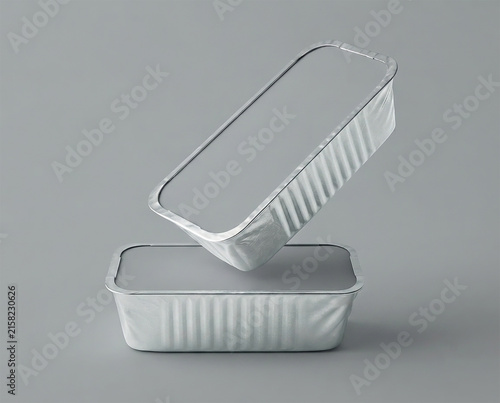 Two silver rectangular containers stacked on a gray background with one container on top of the other