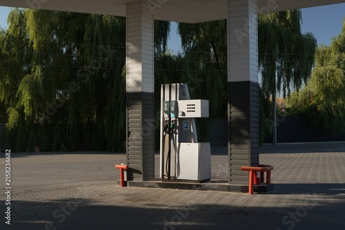 Fuel dispenser at a gas station with diesel and gasoline pumps outdoors