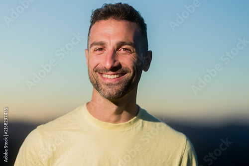 Happy man smiling outdoors during a climbing day