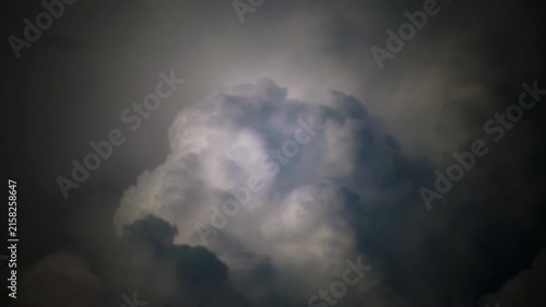 Brilliant lightning cuts through dense storm clouds after dark, revealing a powerful atmospheric spectacle and the raw energy of severe weather, creating a striking scene of nature and tension.