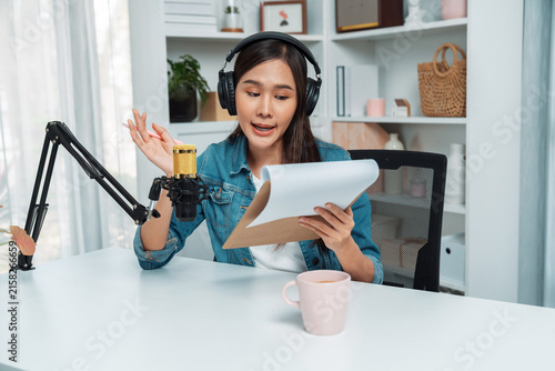 Bild auf Leinwand Host channel of young beautiful Asian wearing jeans creative broadcaster talking in online broadcast explaining to promote marketing or consultant in daily life with listener at studio