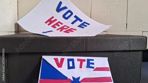 Bild auf Leinwand Handmade paper signs showing vote here message on black ballot box
