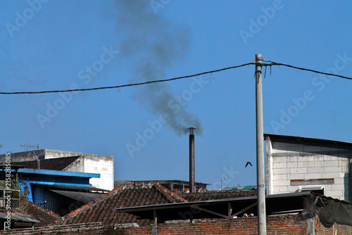 Urban Rooftops With Chimney Smoke Over Old Buildings Showing Air Pollution And Industrial Atmosphere