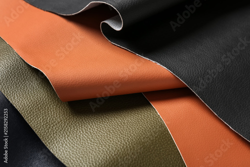 Bild auf Leinwand Assortment of textured Faux leather fabric swatches in black, brown, and olive g