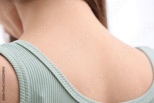 Canvas Print Womans bare neck and shoulder with a light green ribbed tank top, close up view